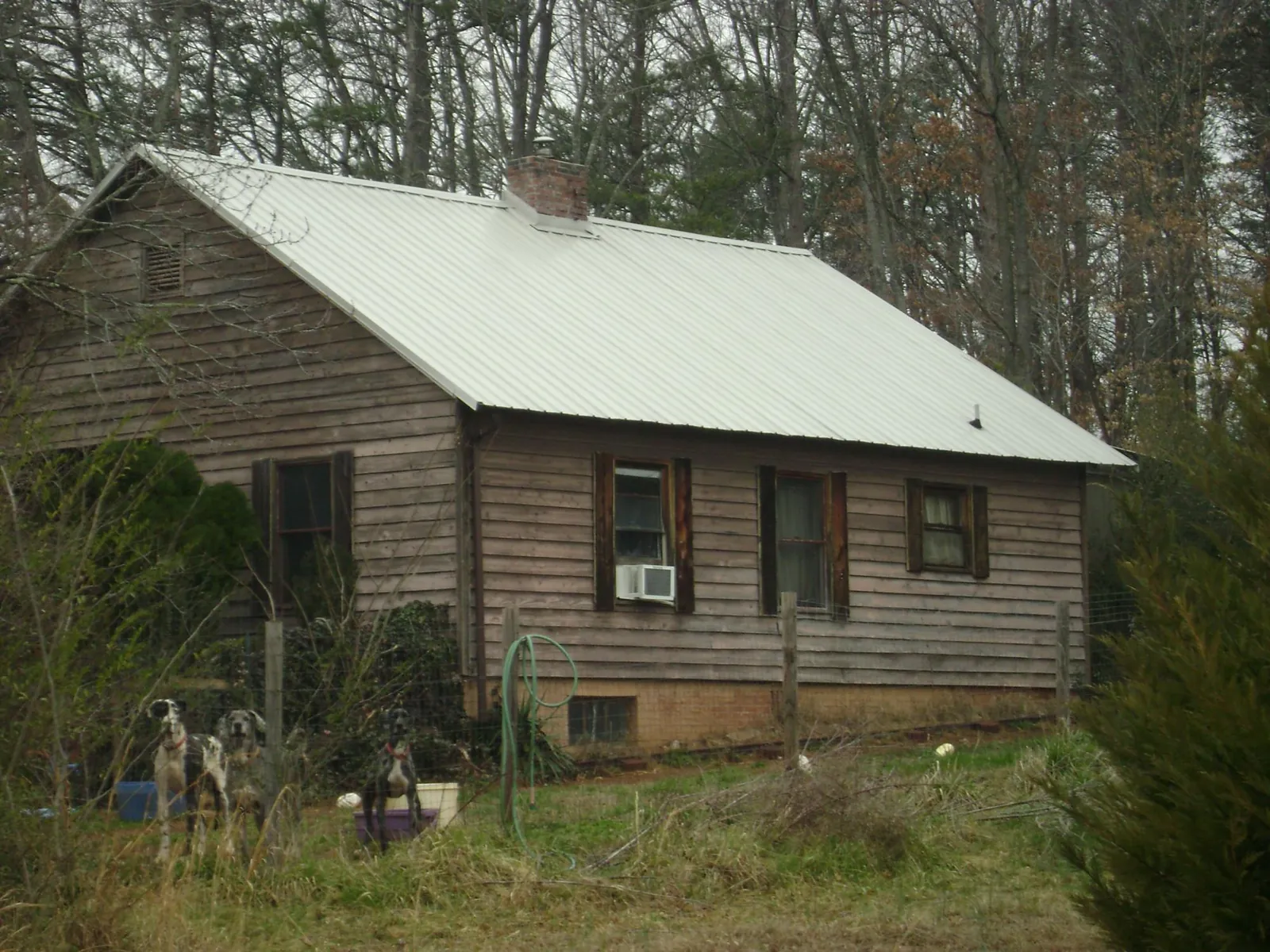 White metal roof on an old wood sided farmhouse, from a Metal Roof Installation job in Richford